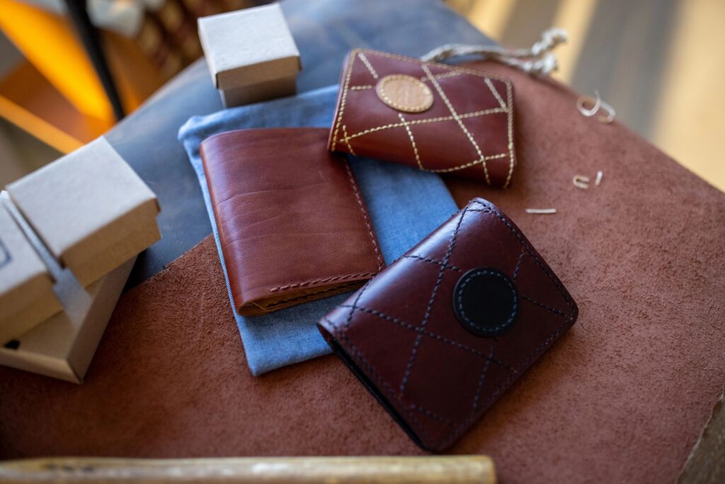 Handmade leather wallets on table in leather crafting workshop