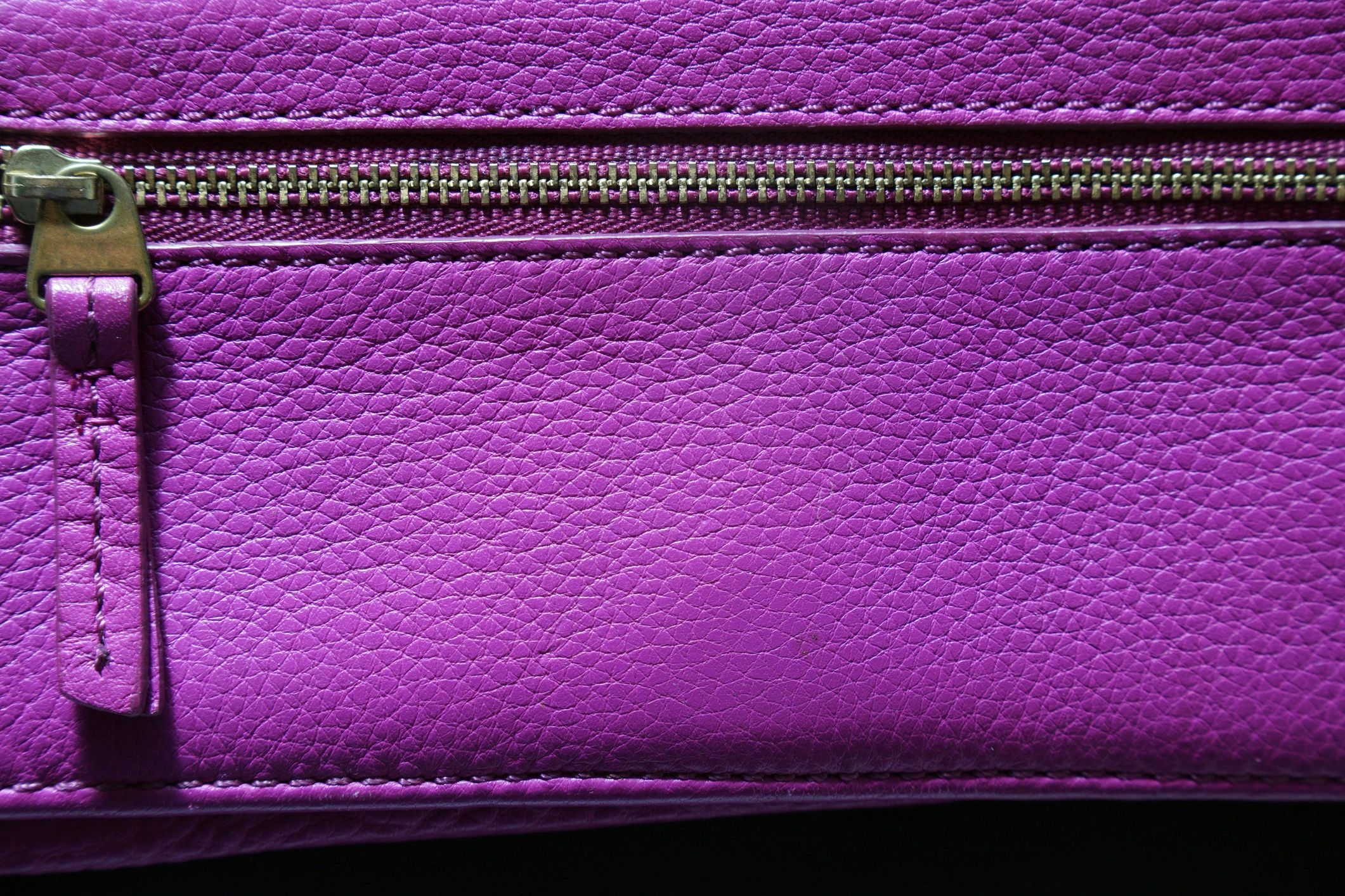 Close-up of a leather bag showing texture and zipper detail